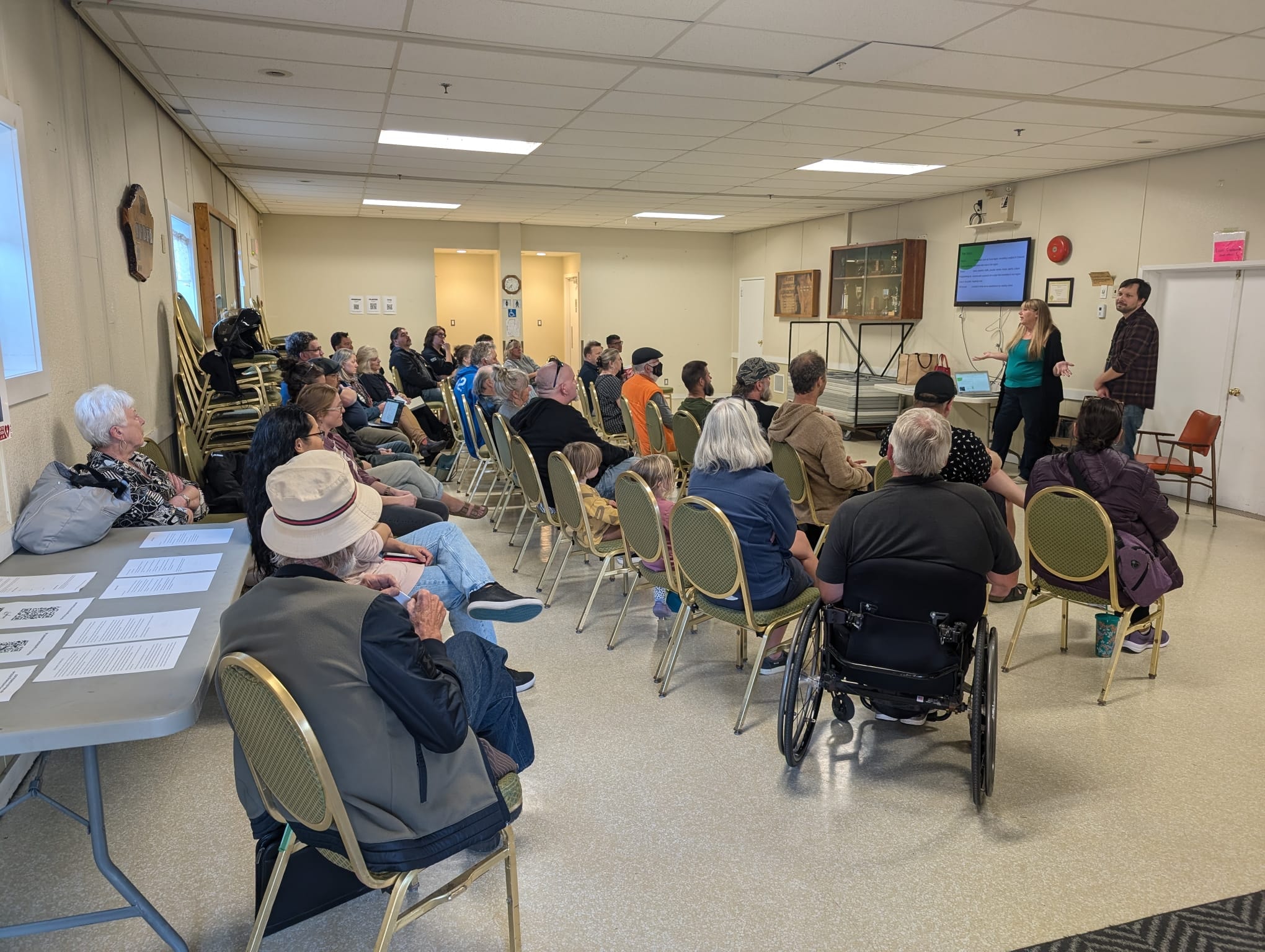 Community members gather to hear Sue and Schuyler present their vision for the radio station.